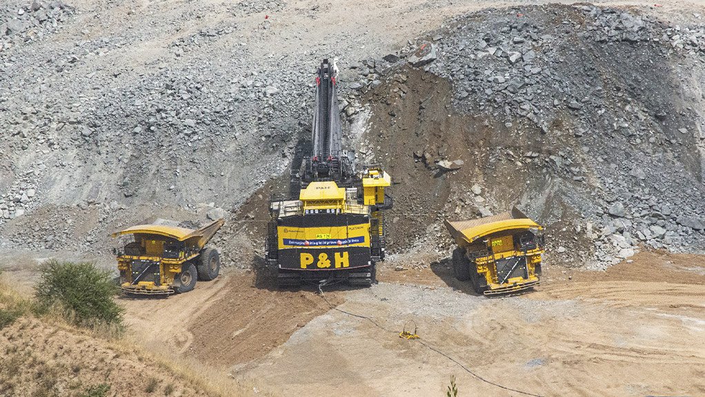 Two Komatsu 930-E 291-tonne capacity trucks are dwarfed by the P&H 4800XPC at Mogalakwena. Both machines are electrically driven, either via the green grid or hydrogen

