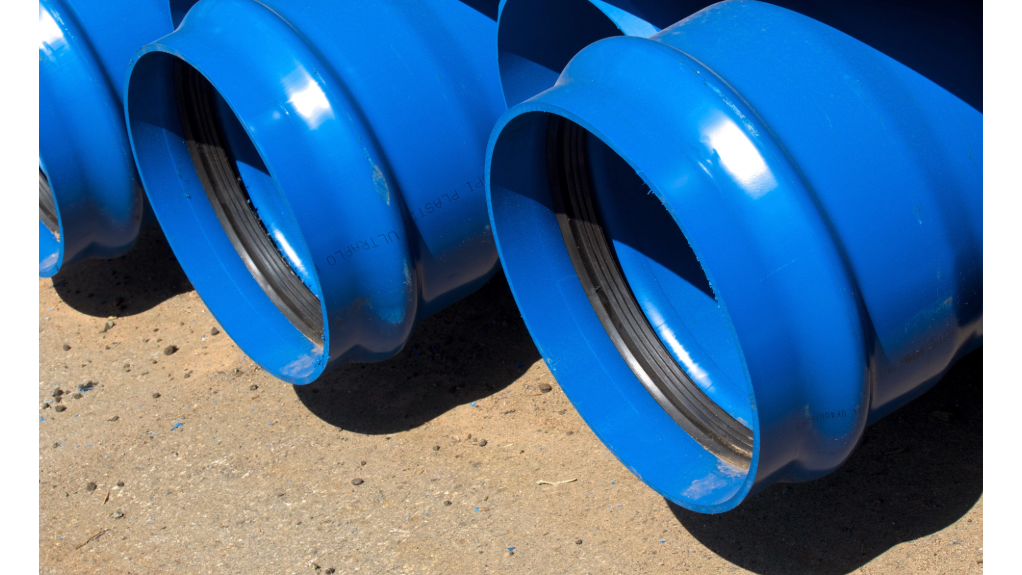 Blue PVC pipes stacked after being manufactured