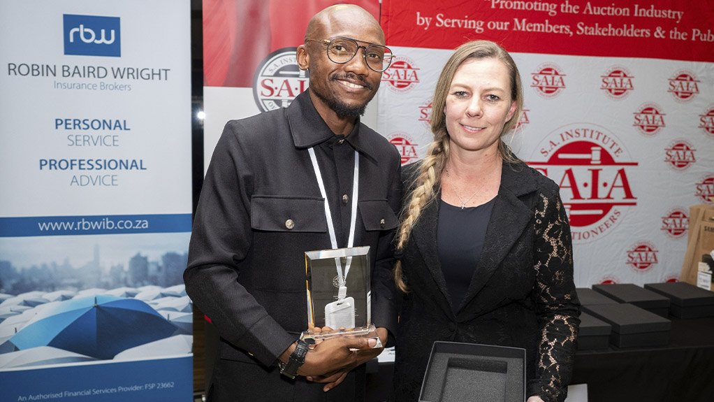 SAIA Most Improved Auctioneer, Kwanele Boltina, receives his award from Sonja Styger 