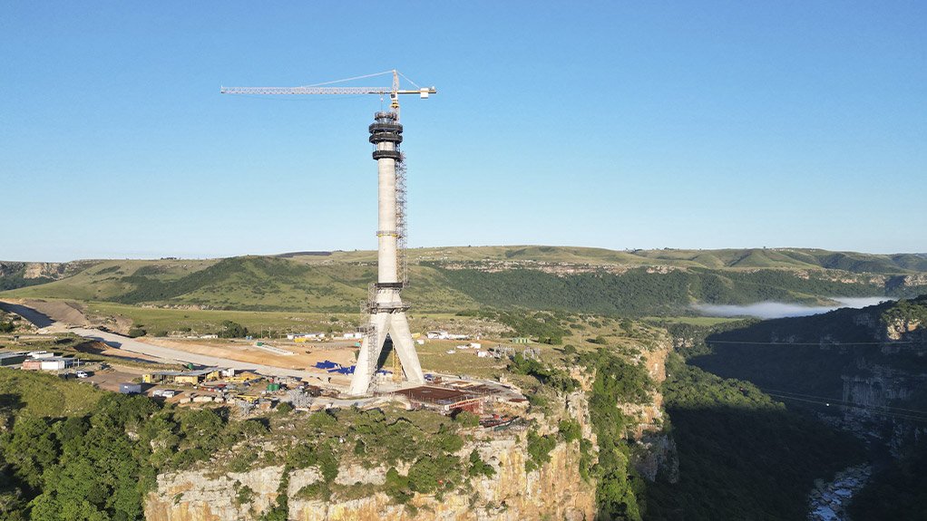 The pylon spires of South Africa's Msikaba Bridge mega project are on their way up, soon to tower almost 130 m high at each side of the near 200-m-deep river gorge.