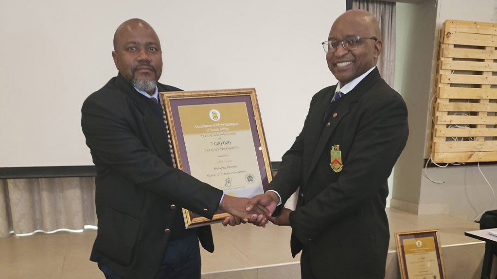 From left, Kethu Mokgatlha, Project Executive at Murray & Roberts Cementation receiving the award from AMMSA President Mosala Letebele in recognition for the company reaching 7 million fatality free shifts