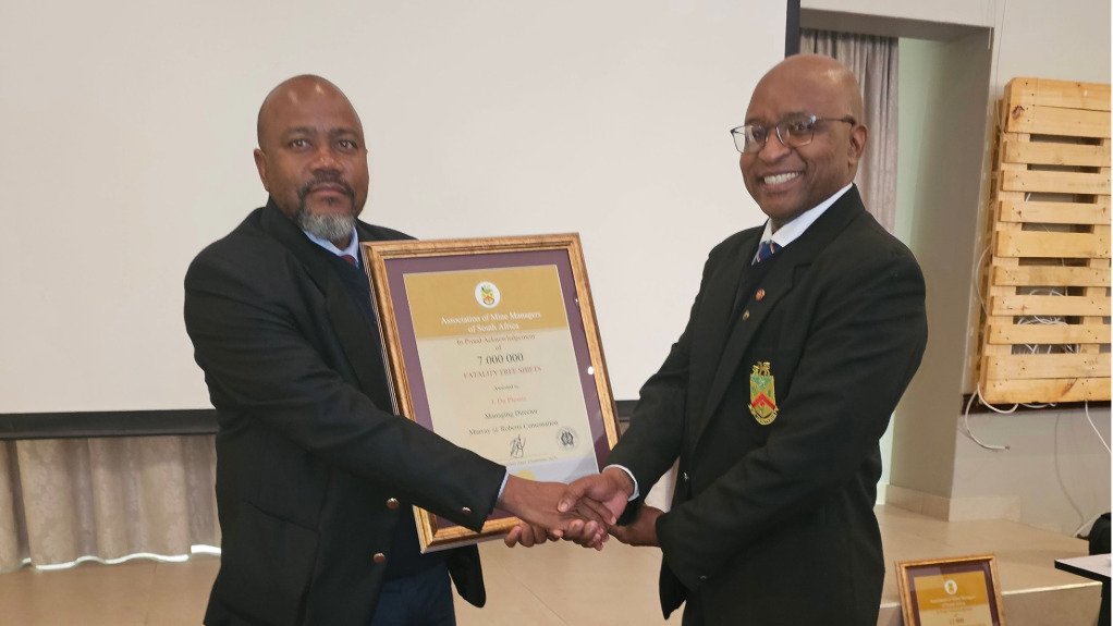 From left, Murray & Roberts Cementation project executive Kethu Mokgatlha receiving the award from AMMSA President Mosala Letebele in recognition for the company reaching seven million fatality-free shifts