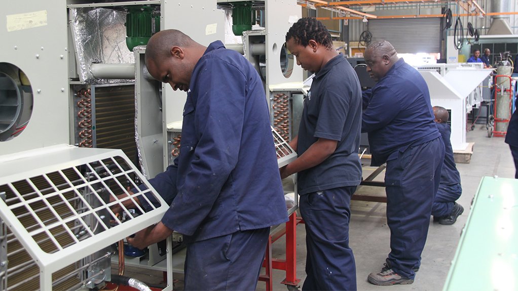 Image of factory workers constructing Booyco HVAC systems