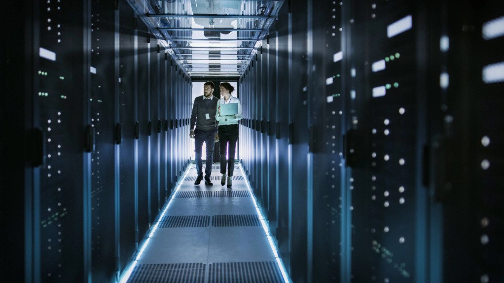 Two employees in a data centre server room
