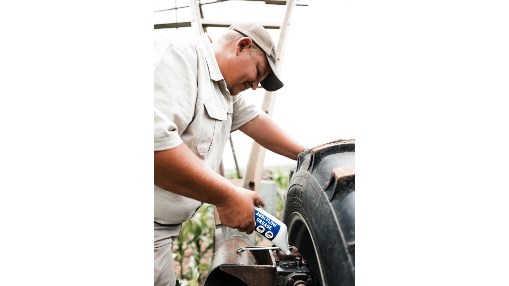 An image of a worker inserting the flow grease into a pivot gearbox