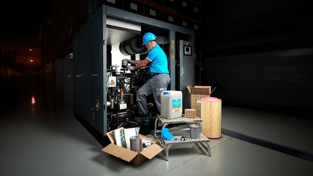 Image of a technician servicing a machine