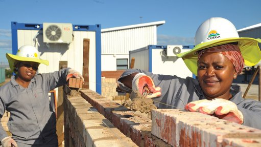 Workers laying bricks