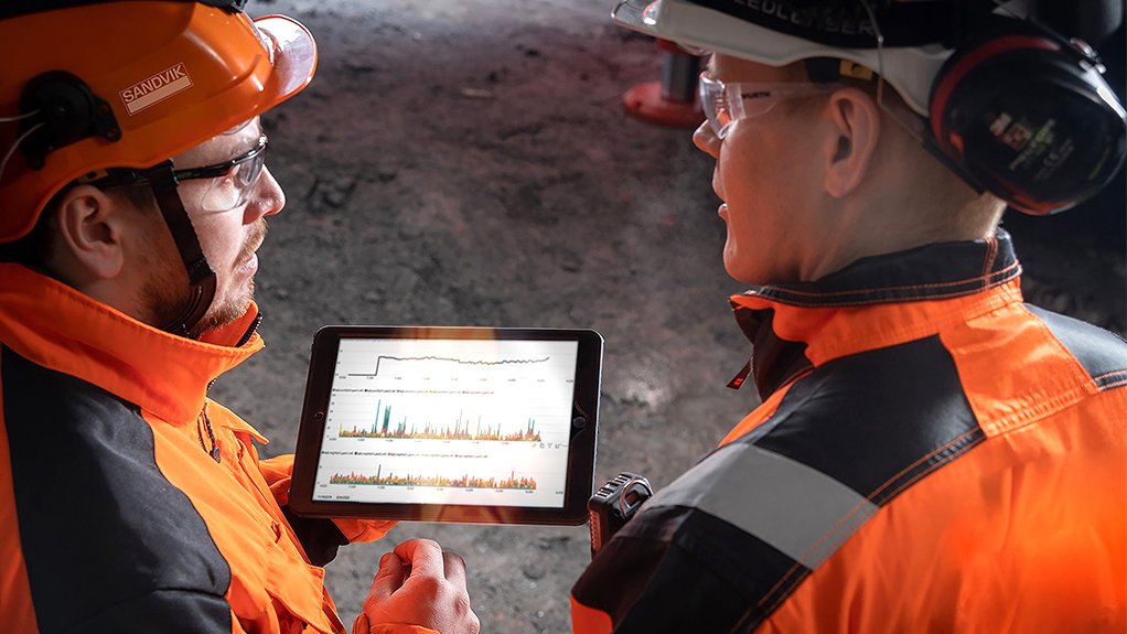 Image of two people underground viewing a mobile device