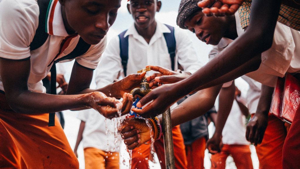 School boys drinking running water provided by De Beers at Renaissance Secondary School