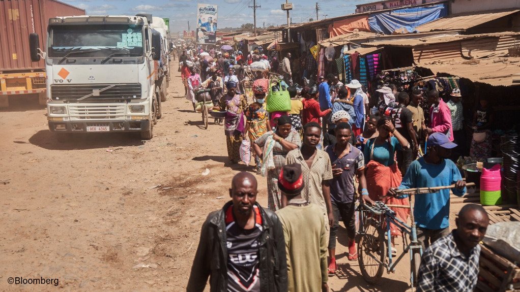 Trucks and people at a border post between the DRC and Zambia