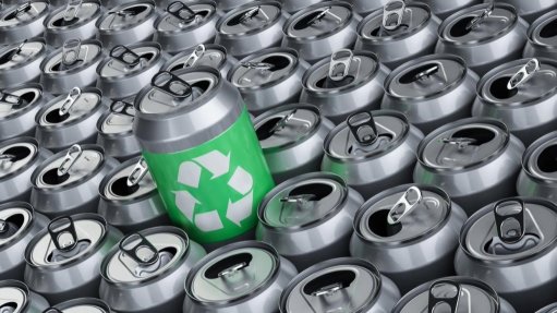 A group of aluminium tin cans one with a green recycle logo on it