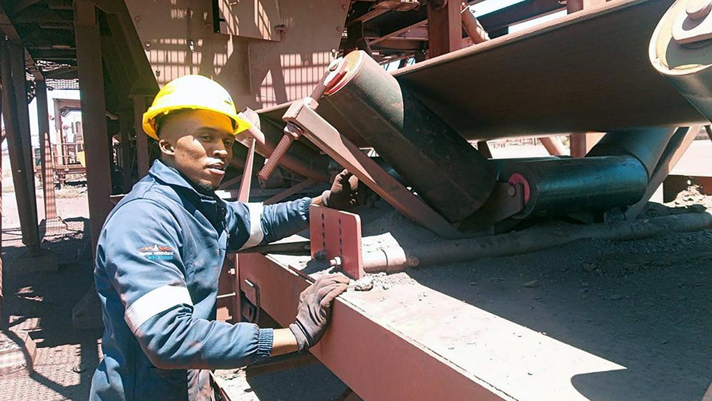 Image of a Tru-Trac employee conducting conveyor maintenance 