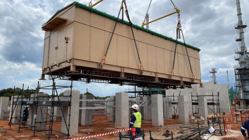 One of the WEG E-house pods being rigged into place