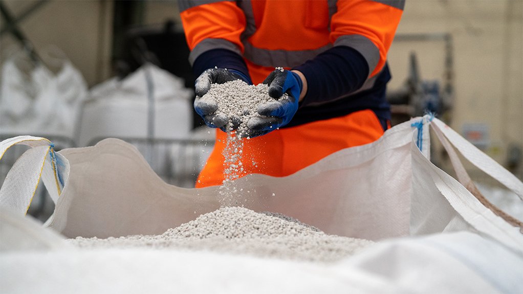 polyhalite being held in gloved hands