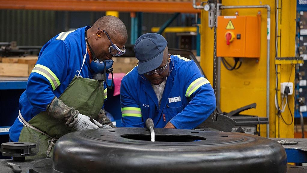 Image of workers in factory manufacturing rubber linings for pumps