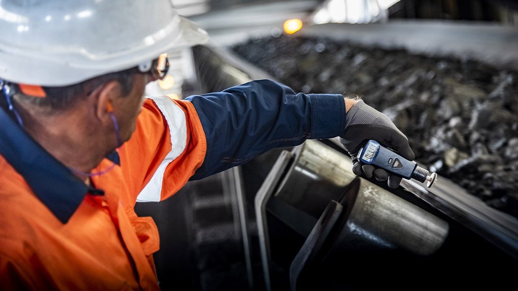 A technical advisor from Weba Chute Systems measures belt speed to ensure optimal material flow and minimal impact on the transfer chute