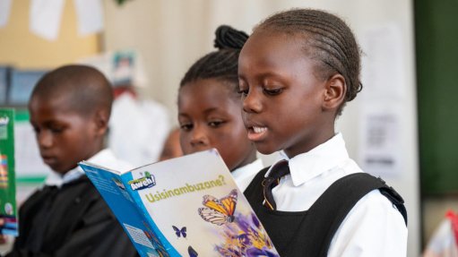 The above image depicts a young student reading at the for Rally to Read initiative