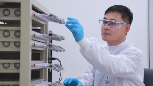 A photo of Dr Cheng Zhang working on a machine