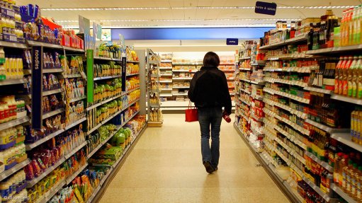 A customer walking in a grocery store aisle