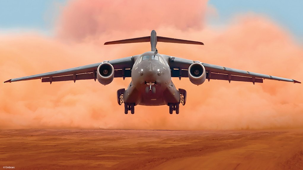 A C-390 takes off from an unpaved runway