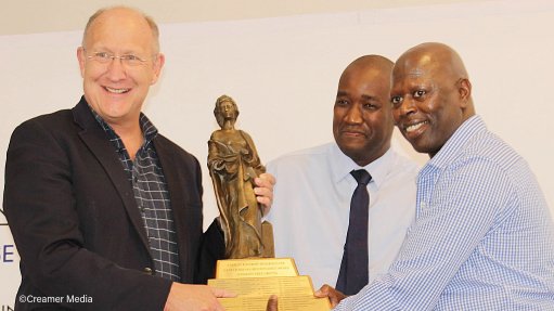 From left, Assmang director Andre Joubert, DMRE Northern Cape principal inspector Tumelo Mateta and BRMO senior GM Xolani Qamata surrounding the Santa Barbara trophy, awarded to an operation that completes one million, or a multiple thereof, fatality free shifts