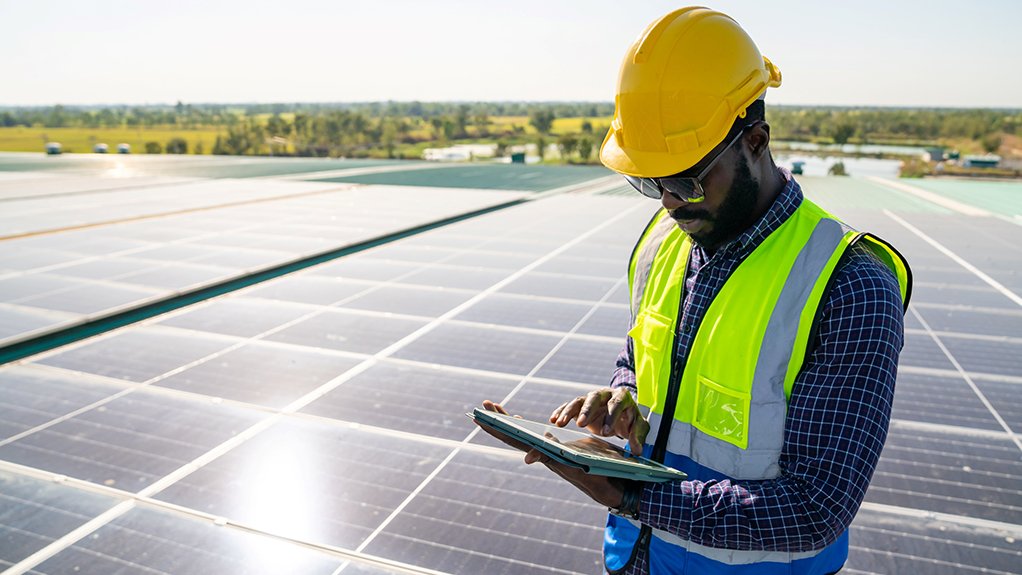 Image of a man checking solar panels