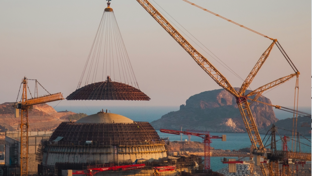 Image of the dome of the outer containment being positioned into place