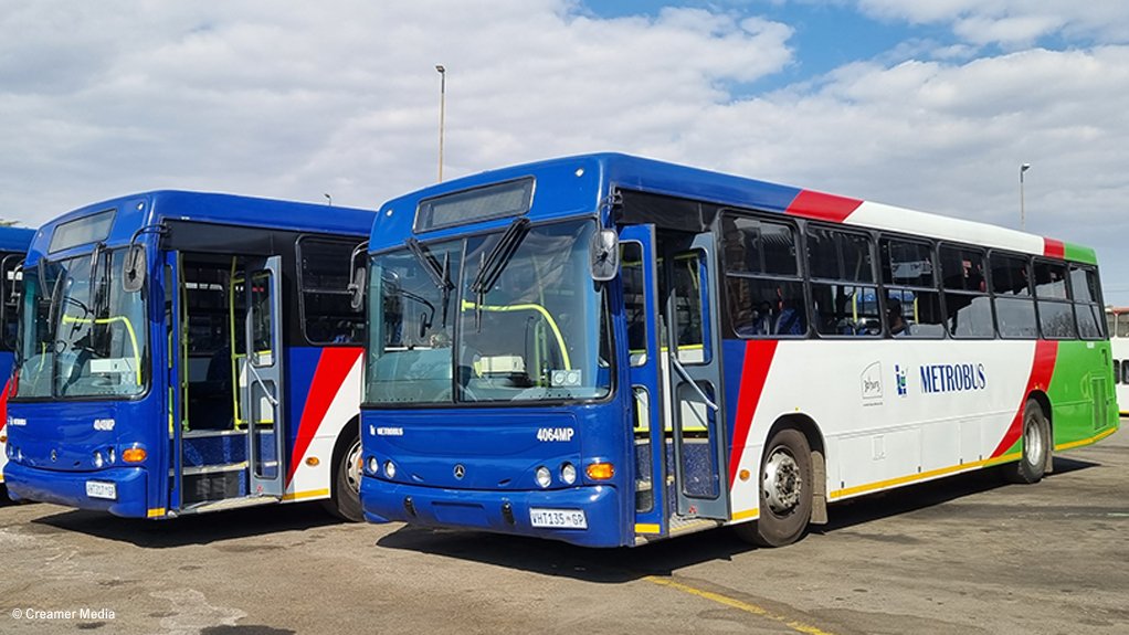 Three Metro Bus busses lined up next to each other at a depot