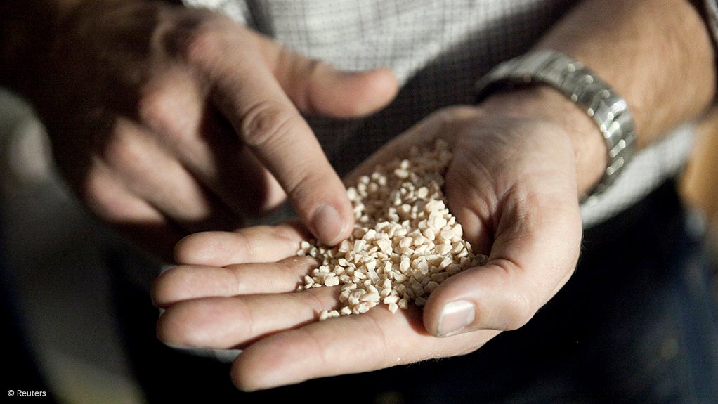 A person holding potash