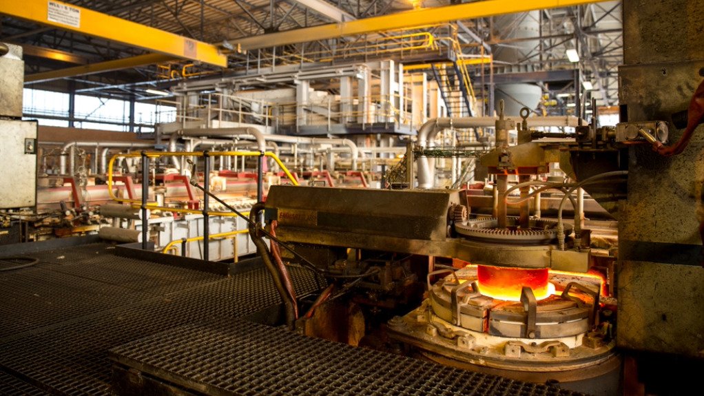 A factory manufacturing steel components with a furnace in the foreground