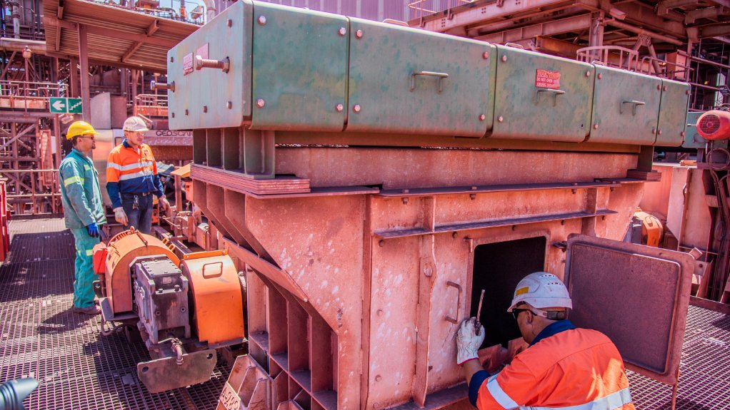 A Weba Chute Systems site manager inspecting a sampler chute. Easy-access chute designs facilitate quick and efficient inspections