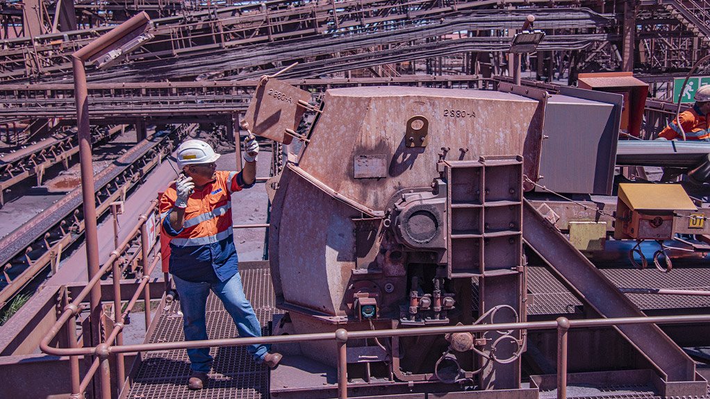 A Weba Chute Systems site manager inspecting a Weba Super Flow chute. Advanced chute technology ensures smooth material flow and reduces wear at transfer points