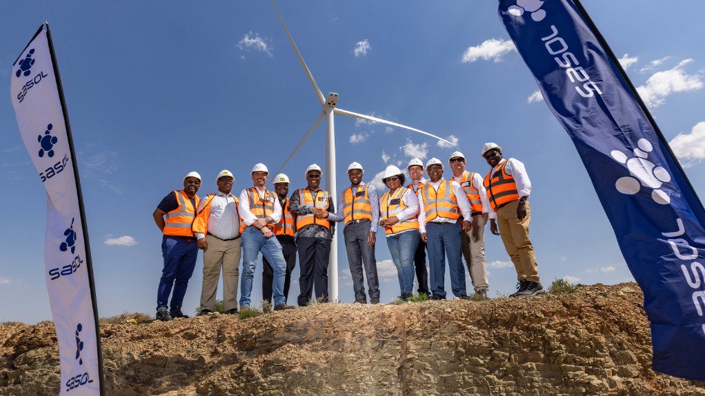 Sasol president and CEO Simon Baloyi (centre right) on site with the Msenge Emoyeni Wind Farm team.