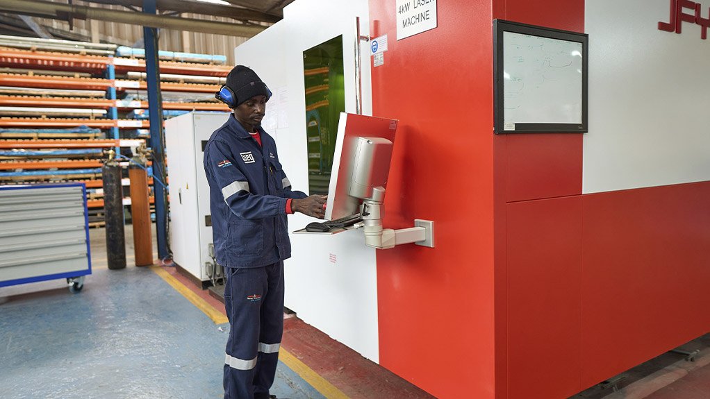 WEG machine operator inputting data into the new laser machine