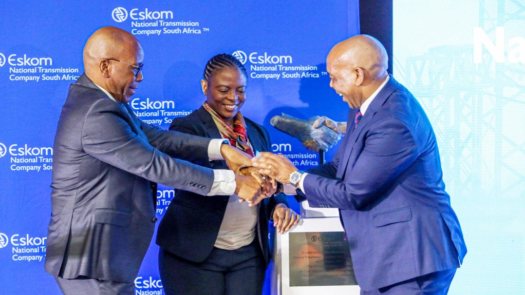 Eskom Holdings chair Mteto Nyati, NTCSA chair Priscillah Mabelane and Electricity and Energy Minister Kgosientsho Ramokgopa joins hand in front of a new ceremonial statue displaying a handshake, unveiled during the official launch of NTCSA on October 7