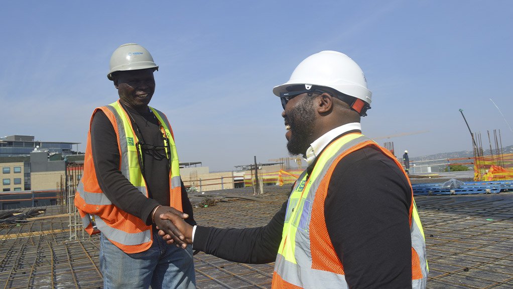 On the right, David Akinnusi, Senior Quality Assurance and Quality Control (QA/QC) Manager at Concor Construction, on site