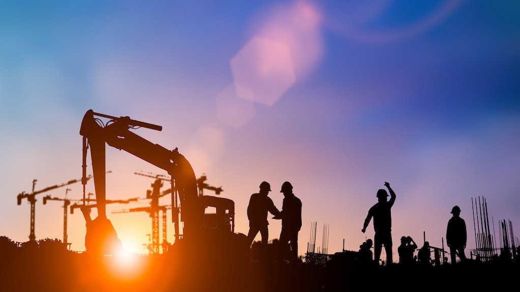 Image of construction workers/cranes/buildings