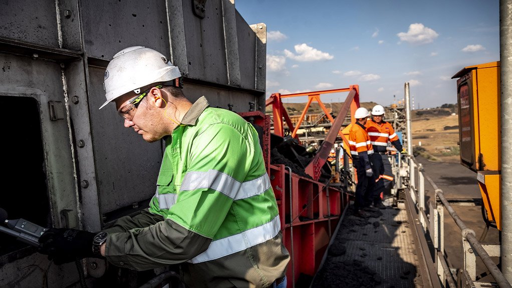 A Weba Chute Systems manager conducting dust tests at a Weba chute, ensuring that the design’s dust control measures are working effectively in the field