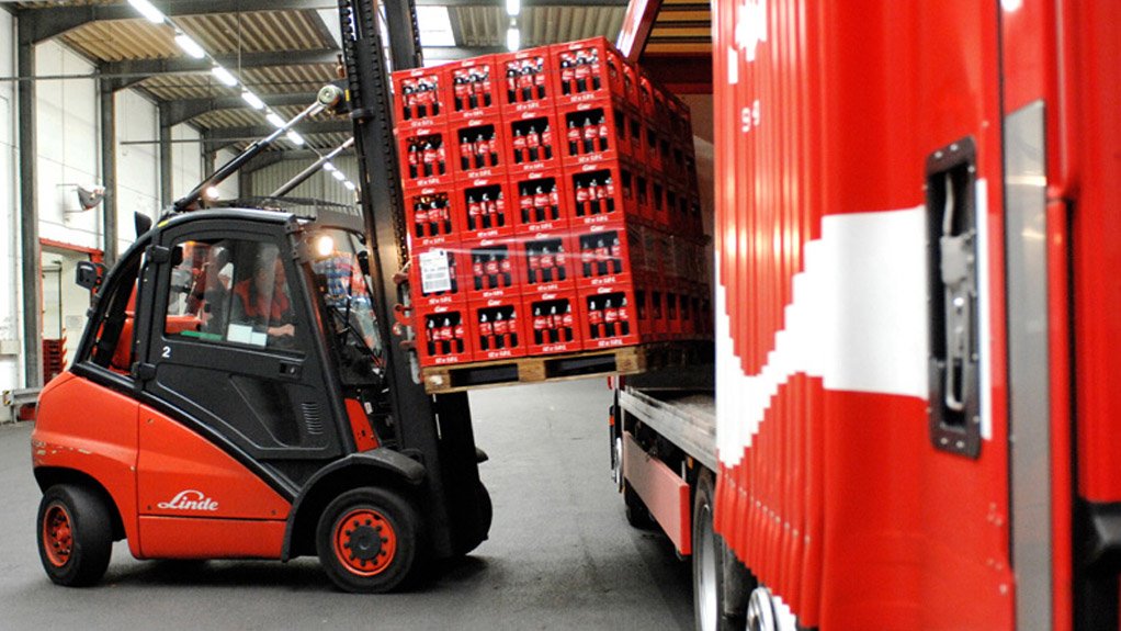 Crates of Coca-Cola being loaded onto a truck