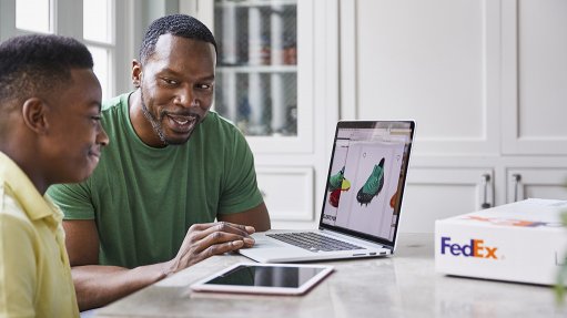 Image of two people viewing a laptop