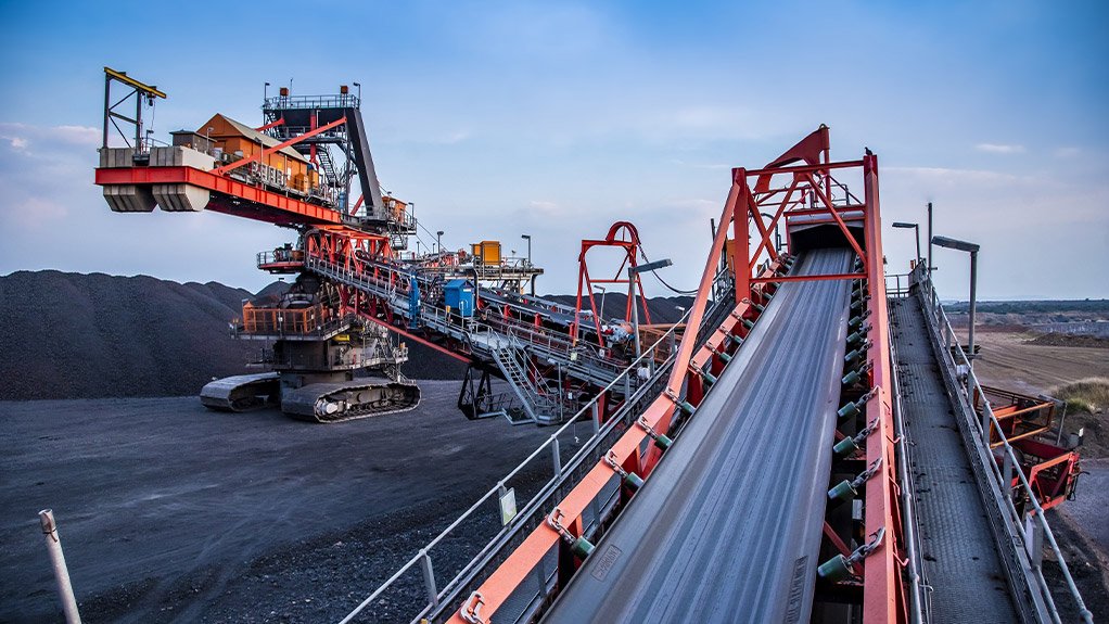 Conveyor belts channel ore smoothly into a custom-designed Weba Chute ensuring controlled flow and minimal wear in abrasive conditions typical of Southern Africa's mining operations