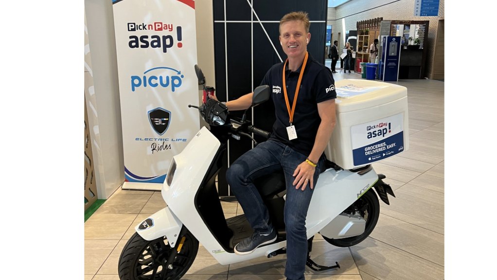 Bruni with an electric scooter