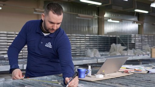 An employee studying drill core