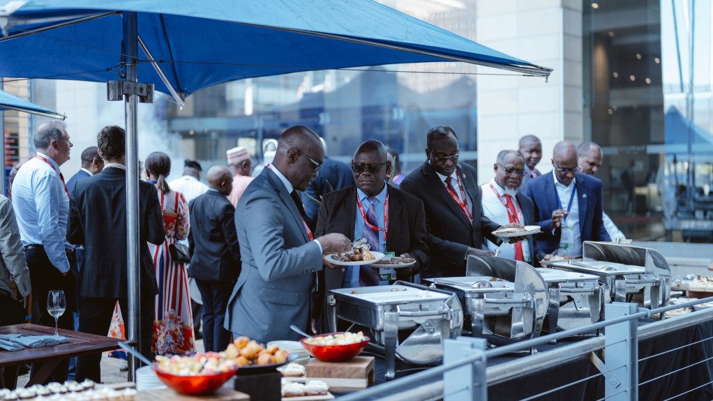 A picture of dignitaries dishing up food at the Heads of State social held at last year's Indaba