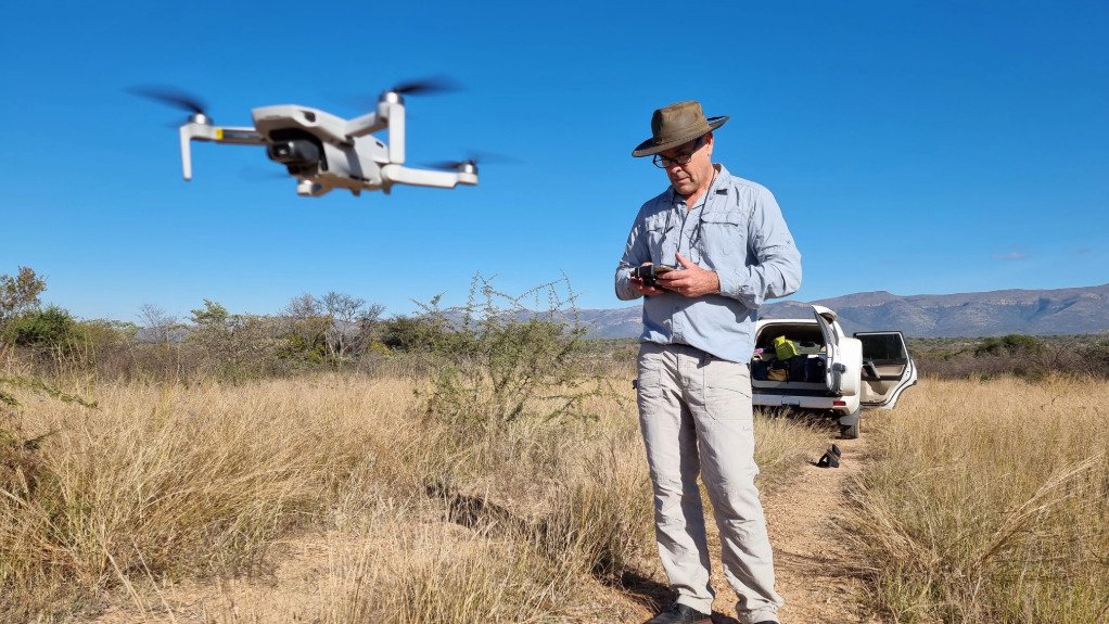 A man flying a drone out in the bush