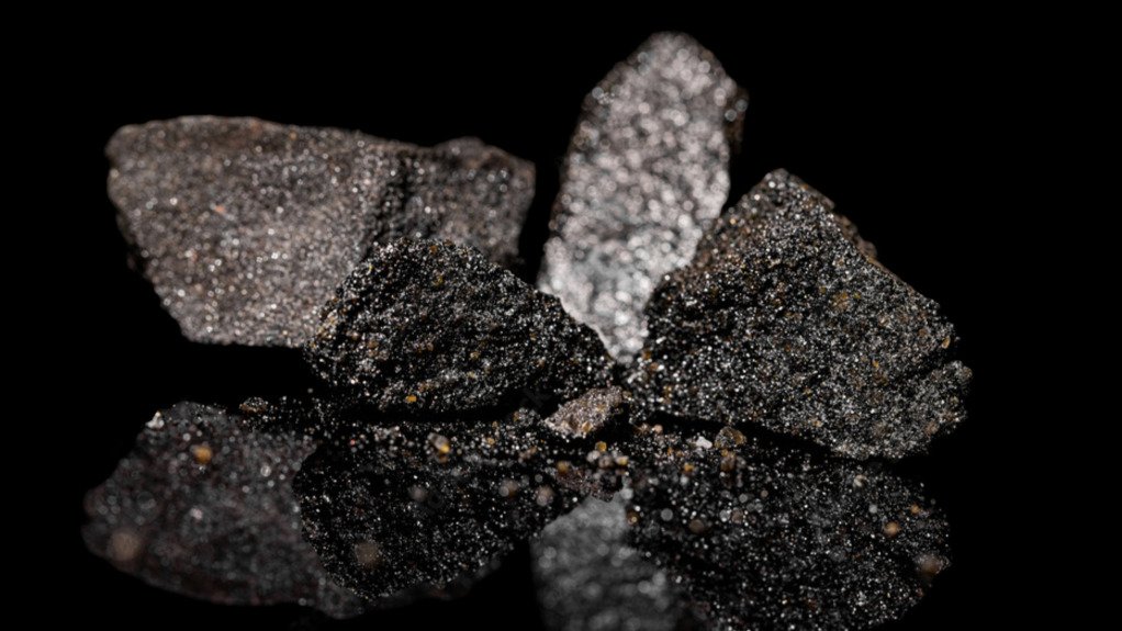 Various grades of platinum ore on a black surface