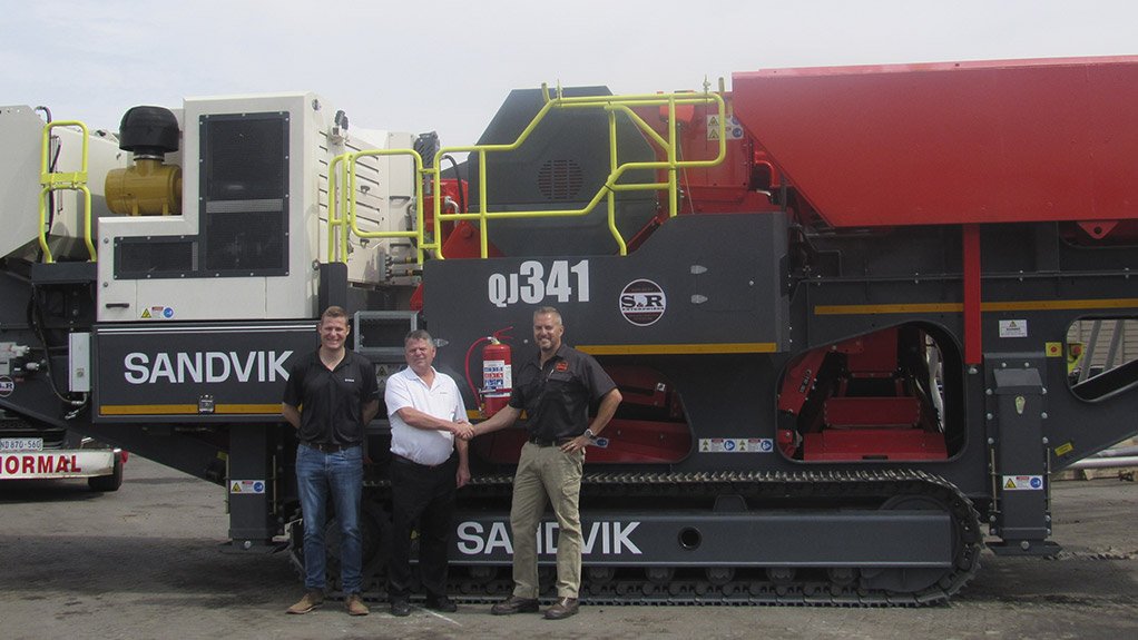 From left : PC Kruger, Business Line Manager Crushing at Sandvik Rock Processing, Jaco Benade, Distributor Manager at Sandvik Rock Processing and Stephen Smith, Managing Director of S&R Enterprises in front of the first Sandvik unit sold by the newly appointed distributor