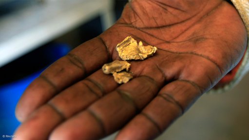 Hand holding illegally mined gold