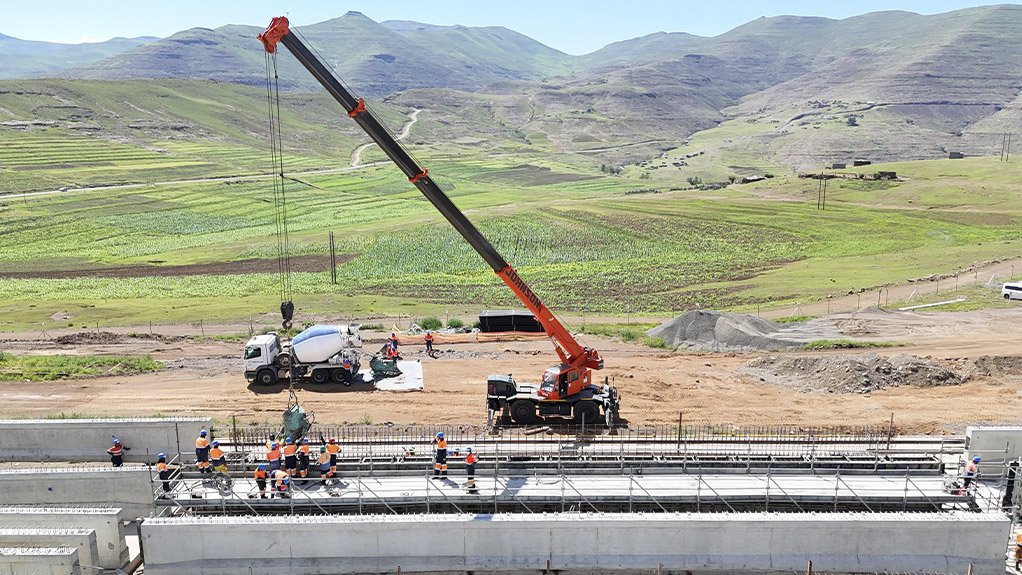 Readymix concrete being poured for manufacture of the precast beams; each beam measures 2,130 m in height and 30 m in length