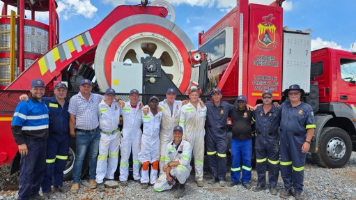 The team from Mine Rescue Services that was involved in the rescue and recovery operation at the Buffelfontein gold mine in Stillfontein, in front of the Mobile rescue winder that extricated the illegal miners